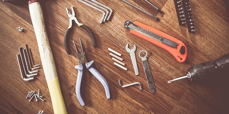 a variety of tools laid out on a bench